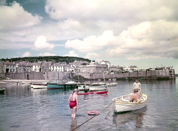 Children and boats in Mousehole Harbour, Cornwall