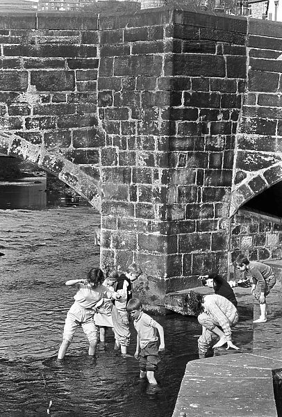 Children play in the water of Hebden Beck