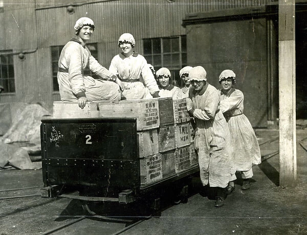 Women riding on cases of TNT, WW1