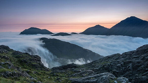 Sunrise behind Bla Bheinn and Marsco with an early morning inversion filling Glen