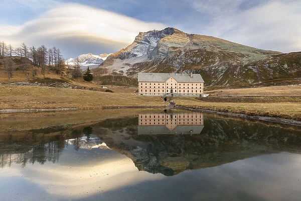 Reflection of the new hospice and Monte Leone in a small pond at the top of the Simplon