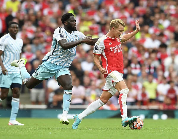 Arsenal vs. Nottingham Forest: Martin Odegaard Tackled by Orel Mangala in 2023-24 Premier League Clash