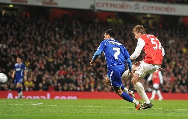Nicklas Bendtner shoots past Ipswich goalkeeper Marton Fulop to score the 1st Arsenal goal