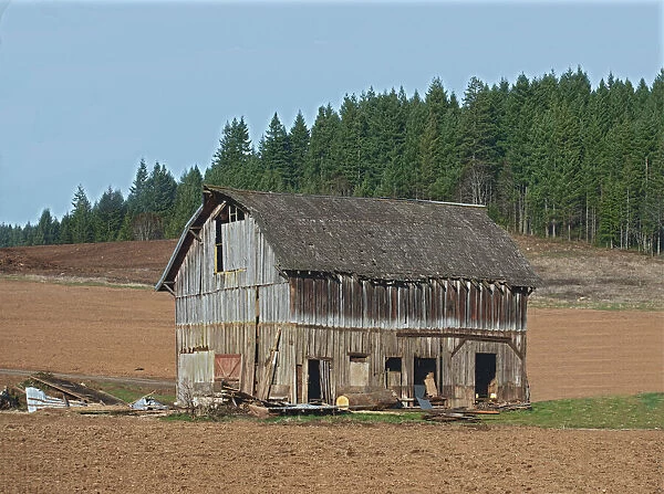 Old Barn. A color photograph of an old wooden barn in an agricultural field