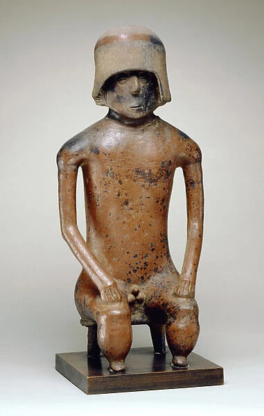Seated male with helmet (earthenware)
