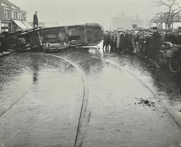 Overturned electric tram and onlookers, London, 1913