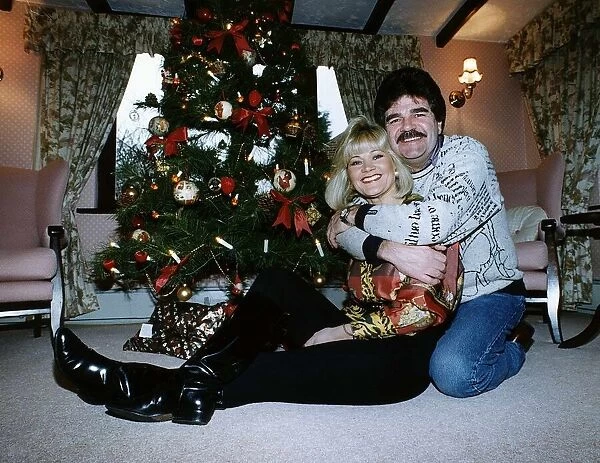 Bob Carolgees Tv Presenter at his home with arms around his wifes neck