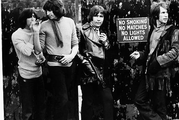 British Sixties pop group The Troggs smoking next to no smoking sign