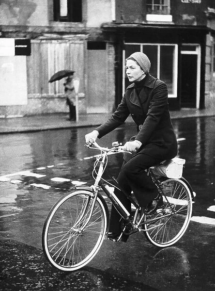 Ingrid Bergman actress riding her bike in the rain dbase MSI brochure