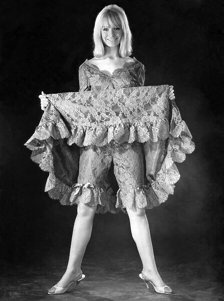A woman showing off her underwear underneath her dress. December 1964