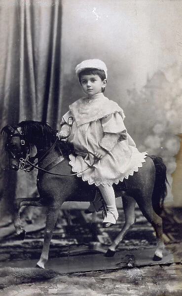 Full-length portrait of a little girl on a rocking horse