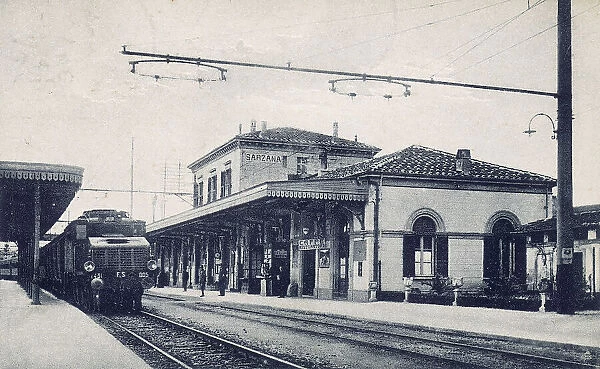 A steam train on the tracks of the train station of Sarzana