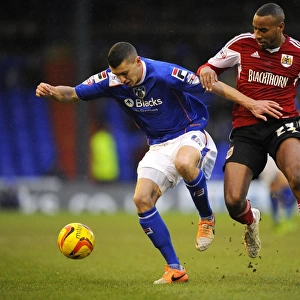 Battling for Possession: Tyrone Barnett vs. James Wilson in Sky Bet League One (Oldham v Bristol City)