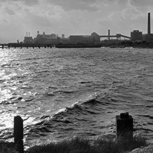 A cement factory at Grays, Essex, England, seen from the River Thames at high tide in