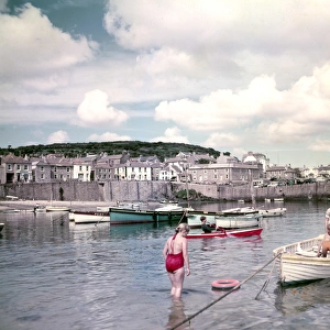 Children and boats in Mousehole Harbour, Cornwall