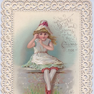 Girl sitting on a wall on a Christmas card