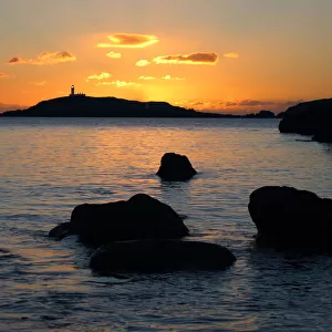The lighthouse on Little Ross Island flashes at sunset
