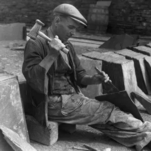 A workman splitting slates in one of the biggest slate quarries in the world