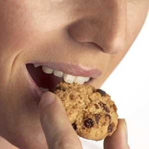 Woman eating a cookie C018 / 1188