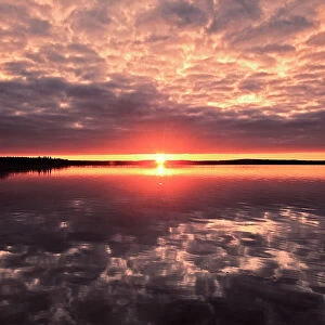 Clouds refelected in Namekus Lake at sunrise Prince Albert National Park Saskatchewan, Canada