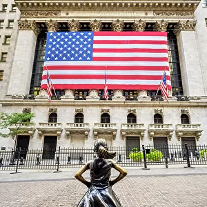 "Fearless Girl"bronze sculpture by artist Kristen Visbal across from the New York Stock Exchange Building, Lower Manhattan, New York, USA