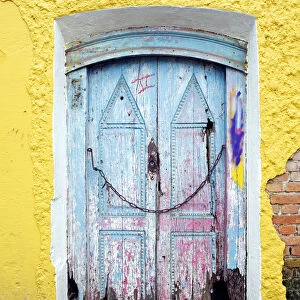 South America, Brazil, Sao Paulo, Embu das Artes, a decrepit wooden door in a building