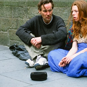 A homeless man and woman sleeping rough and begging on the streets of Leeds UK