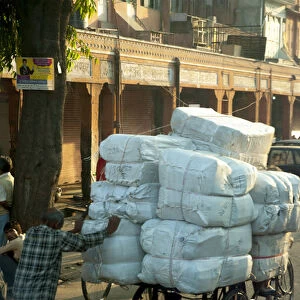 Man pushing an overloaded cart, Jaipur, Rajasthan, India