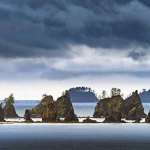 USA, Washington State, Olympic Peninsula. Light breaks through clouds Point of the Arches