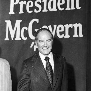 GEORGE McGOVERN (1922- ). American politician. Senator McGovern beneath a poster in New York City, during his presidential campaign, June 1972