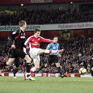 Aaron Ramsey Scores Arsenal's Second Goal Against Stoke City Amidst Pressure from Abdoulaye Faye and Danny Collins