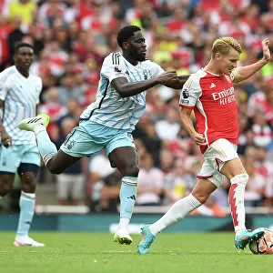 Arsenal vs. Nottingham Forest: Martin Odegaard Tackled by Orel Mangala in 2023-24 Premier League Clash