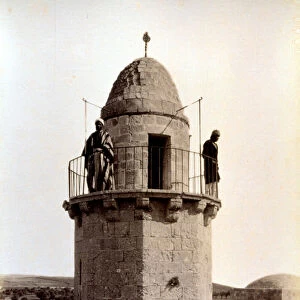 Two muezzin are calling the faithful to prayer from the top of a minaret