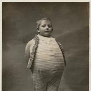 School boy, dressed up to have a very large stomach (b / w photo)