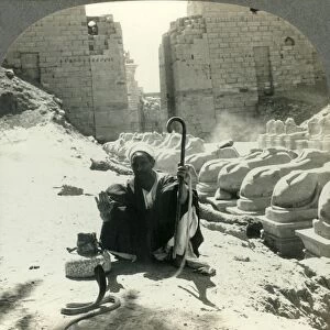An Egyptian Snake Charmer Piles His Trade Beside the Avenue of Sphinxes, Temple of Karnak