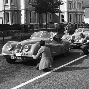 Officials measuring Jaguar XK120, 8 clubs rally Eastbourne 1952. Reg EBN 514. Creator: Unknown