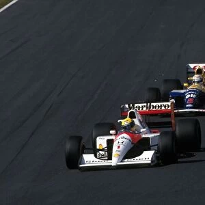 Formula One World Championship: Nigel Mansell following Ayrton Senna closely at Suzuka