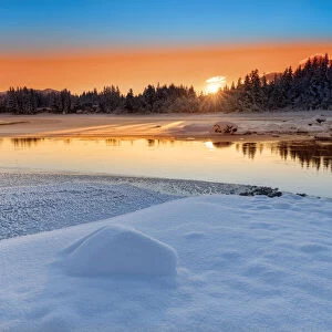 Sunset reflecting over the wintry landscape of the Mendenhall River, Tongass Forest, Alaska, USA