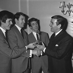 The Bachelors pop group with disc jockey Alan Freeman 1964 being presented with their