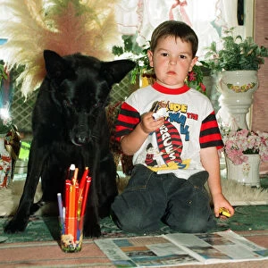 Blackie the dog is pictured with a small boy. 17th June 1993