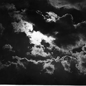 Dark rain clouds with the sun breaking through April 1947