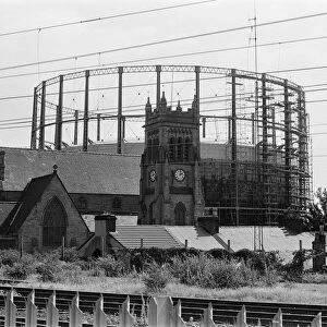 Garston Gasometer, dwarfs church in foreground, Liverpool, Merseyside, 16th August 1988