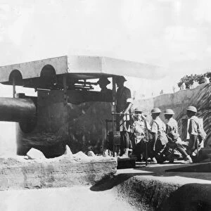 An Indian gun crew working one of Hong Kongs coast defence guns as they prepare for