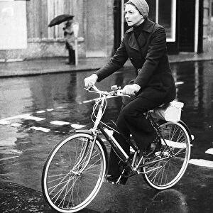 Ingrid Bergman actress riding her bike in the rain dbase MSI brochure