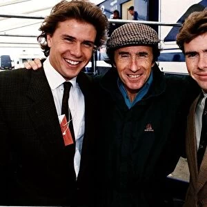 Jackie Stewart with his arms around sons Mark and Paul