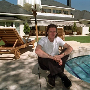 New Real Madrid signing Steve McManaman sitting beside the pool at his new home in Madrid