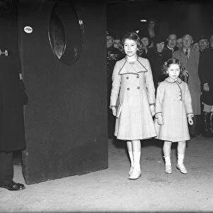 Princess Elizabeth and her sister Princess Margaret arrive at the theatre, circa 1940