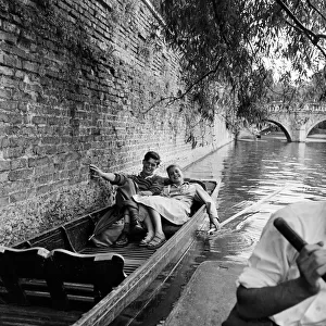 On the river Cam in Cambridge resting in a punt are James Innes of St Catherine