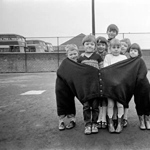 The seven children in the fat mans pullover are (left to right