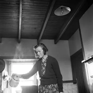 Violet Rosie, a. k. a. The Silent Woman of Swona, pictured at home in cottage, making tea